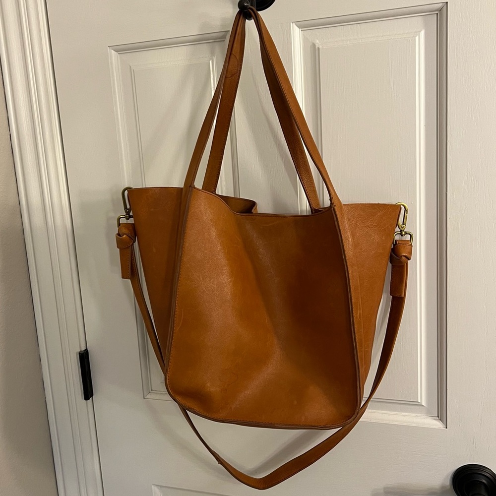Genuine leather. Crossbody strap. Imperfections noted due to normal wear.